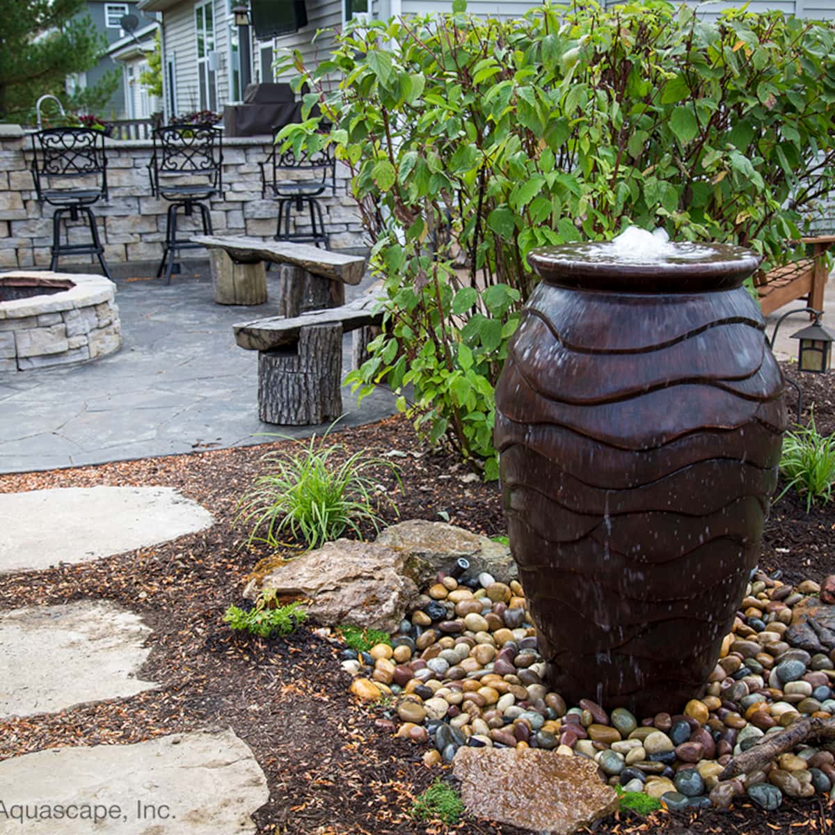 Garden patio with stone fountain and seating area. - Scalloped Urn Fountain Kit – 45″ H (114 cm)