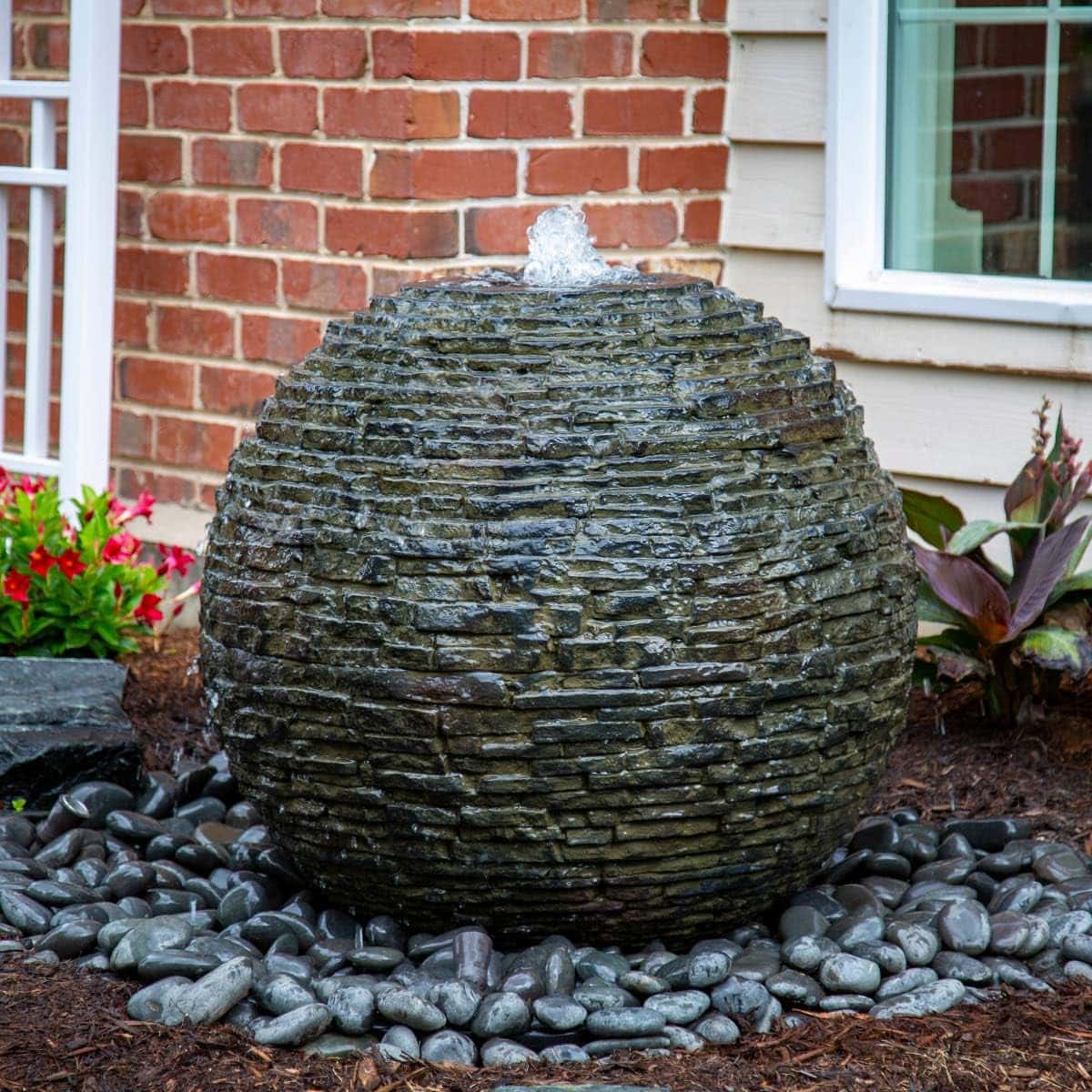 Round stone fountain with water feature in garden. - Stacked Slate Sphere Fountain Kit – 32″ Dia (81 cm)
