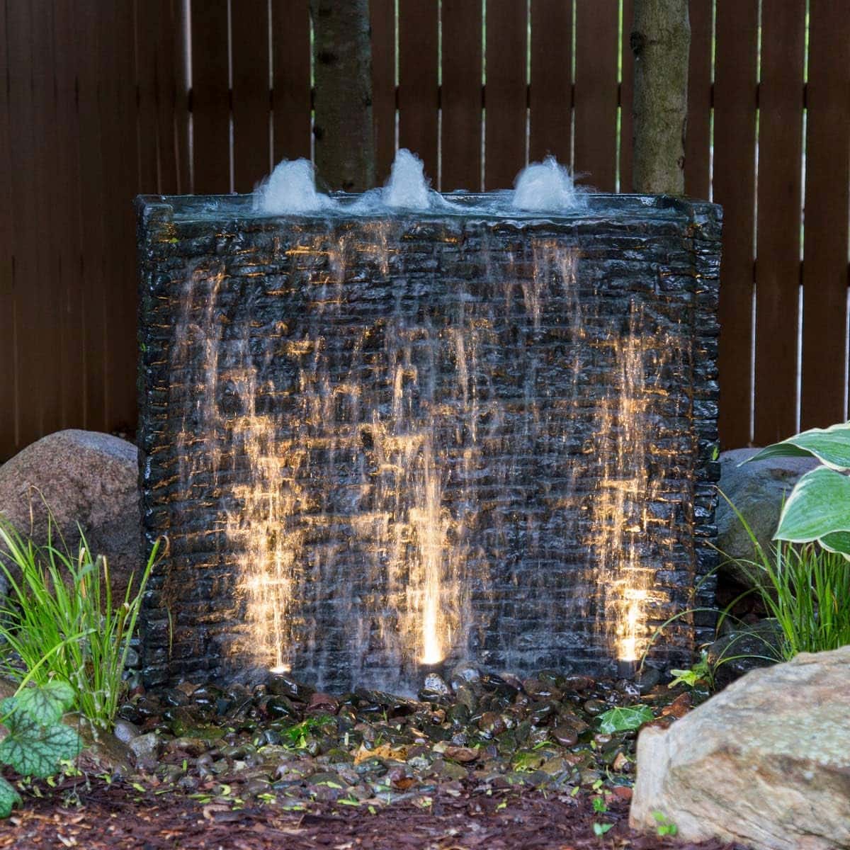 Illuminated outdoor water feature with cascading water. - Stacked Slate Wall Fountain Kit – 32″ H (81 cm)
