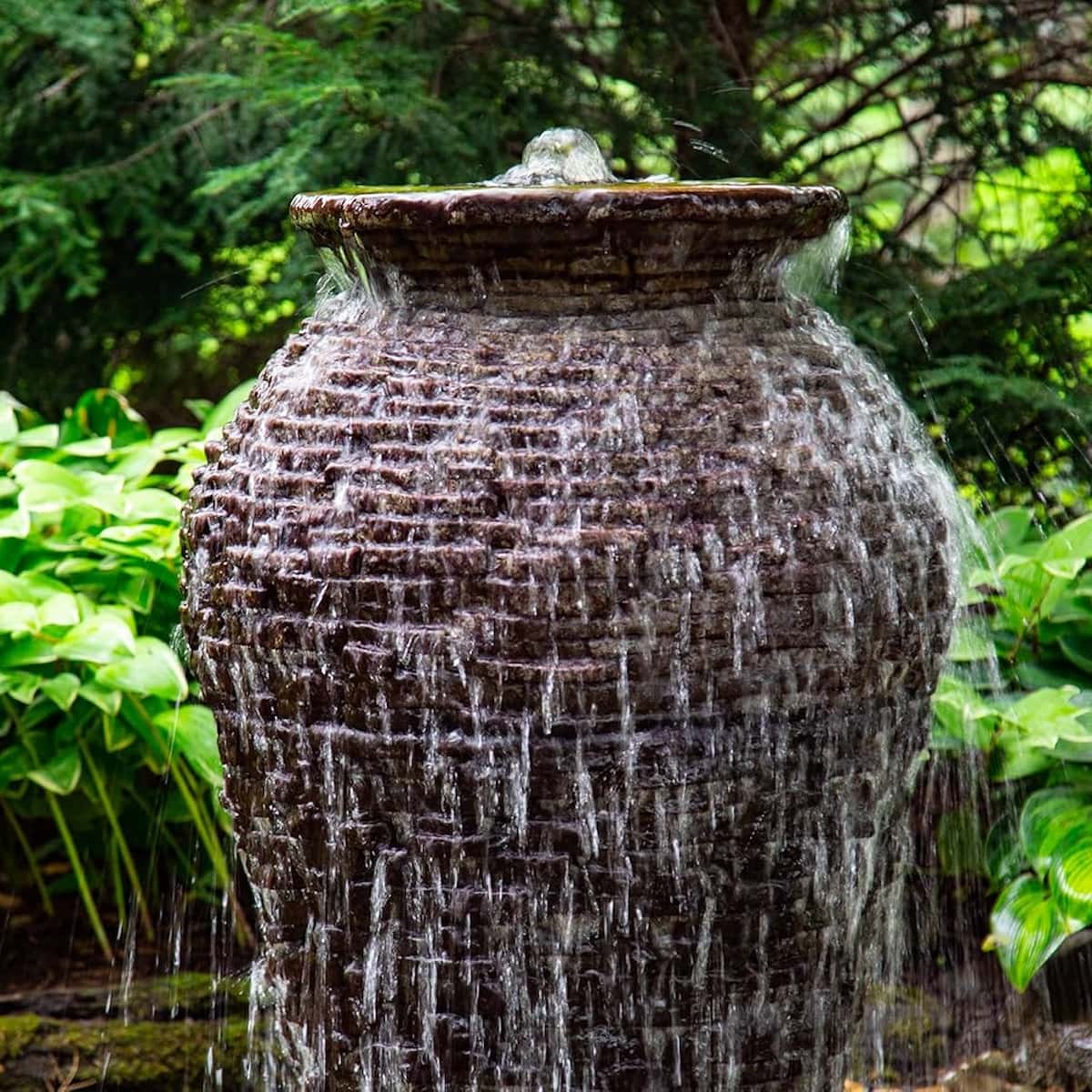 Overflowing garden water fountain with lush greenery. - Stacked Slate Urn Fountain Kit – 45″ H (114 cm)