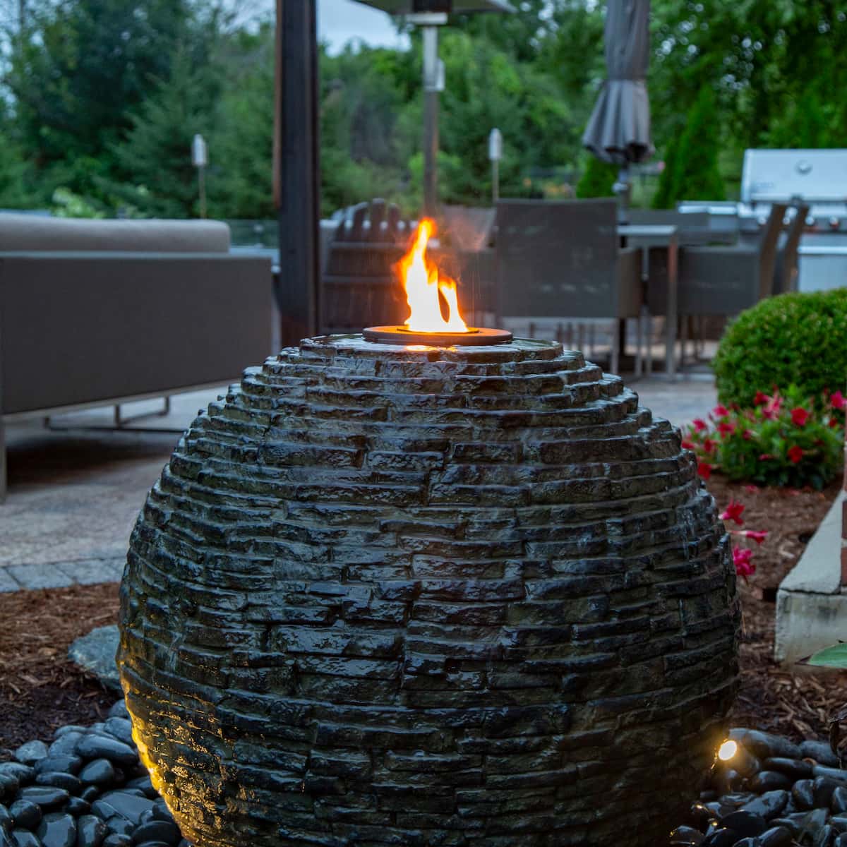Stone fire pit in a garden setting. - Stacked Slate Sphere Fountain Kit – 18″ Dia (46 cm)